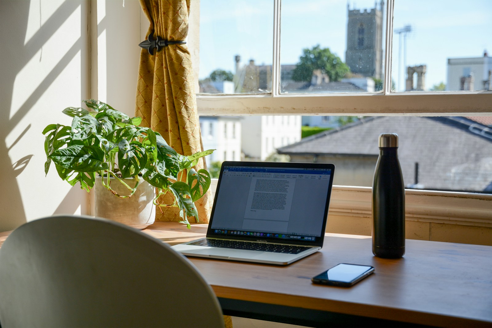 Illustrative scene: a desk by a bright window in a family home