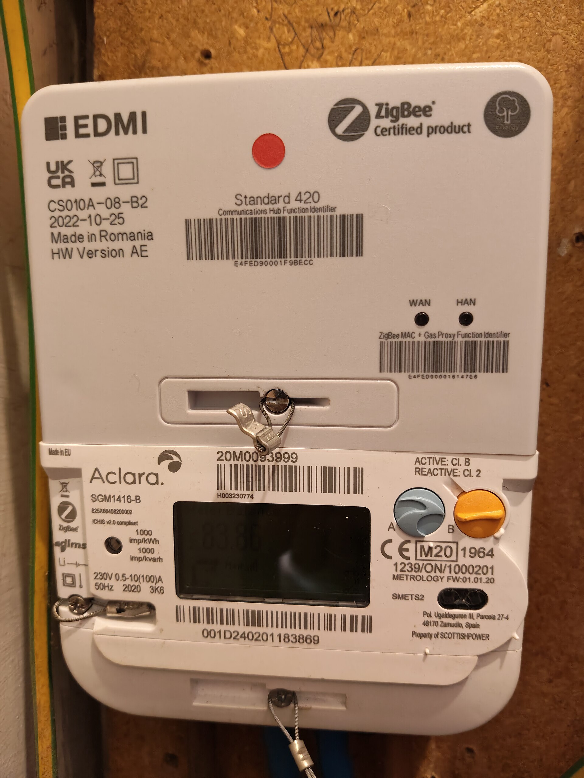 A UK electricity meter and communications hub in a cupboard; metering context.