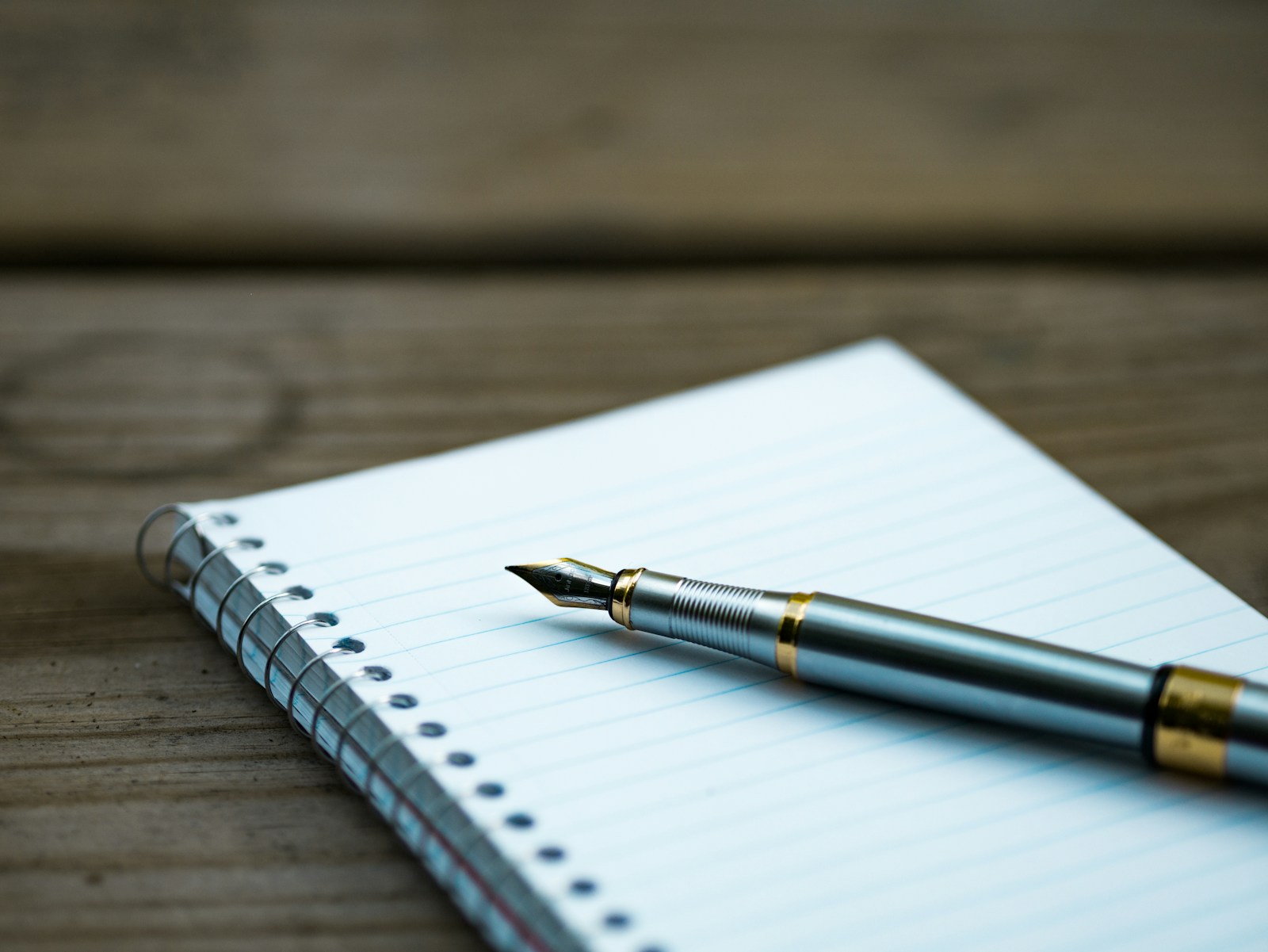 A pen on an open notebook; preparing an equipment-record checklist.